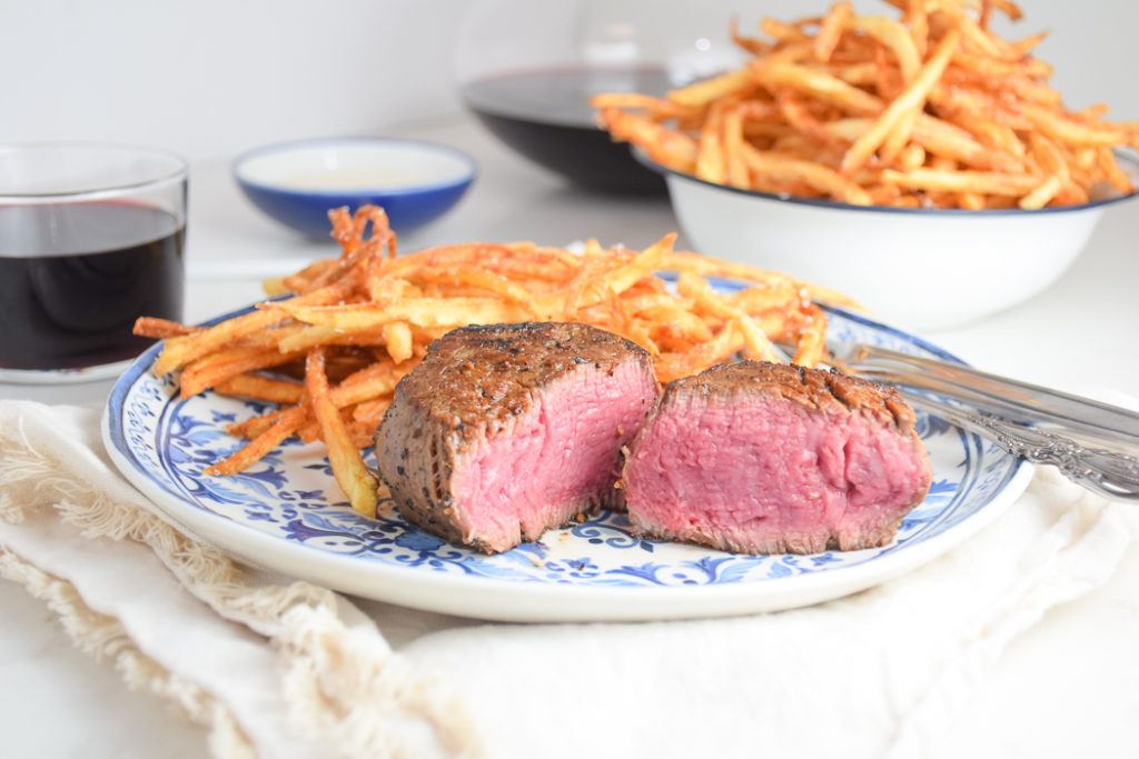 Steak Frites on a blue and white plate